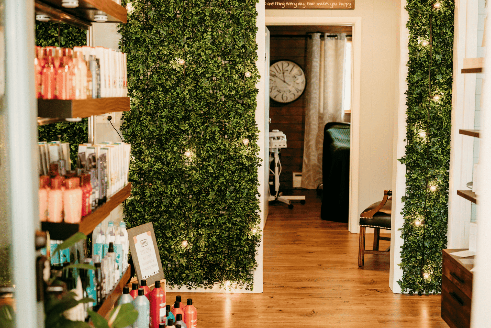Spa interior with shelves of beauty products, fairy lights on walls, and a cozy treatment room.
